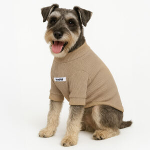 Small dog wearing a light brown polyester rib turtleneck sweater with JoinPet logo, sitting upright with one paw raised on a neutral background